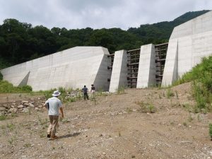 砂防堰堤といわれても想像できないという方のためにまずは見ていただこう。こちらは栂池沢第3号砂防堰堤。斜面に左右178mのコンクリートの塊が作られている。8年かけて作られたものだ