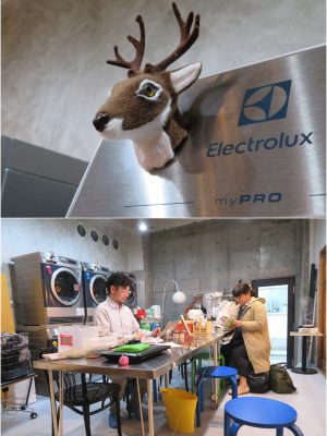 ランドリースペース。予算の関係もあり、コインを入れて自動的に使えるタイプではなく、スタッフに料金を払う必要がある機種が置かれているが、それが会話のきっかけにも。ミシン、アイロンなど徐々にモノが、非実用的なモノも含め、増えている