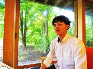 ▲軽井沢総合研究所の発起人のひとりである佐野誠さん。「34年前、竣工直後のハーモニーハウスは人で溢れかえるぐらいの人気ぶりで、いろいろなスポンサーがつき、多彩な音楽イベントを開催していたと聞いています。もともと合宿所として機能するように宿泊施設も備えられていたため、そのスペースは現在シェアハウスとして活用中です。おかげさまで満室状態が続いています」と佐野さん