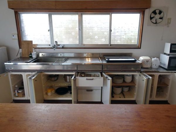 奄美出身の山下さん。自身が設計した「伝泊 The Beachfront MIJORA」のフロントを兼ねるレストラン＆バー「2 waters」の前で