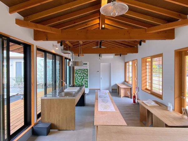 コミュニティハウスを見学する3人。プレゼン前日にデータが消えて焦ったことや、プロを相手に議論したことなど思い出を語り合う