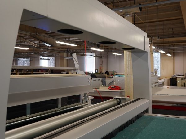 裁断図が投影された革。端の赤い部分は、革が柔らかく伸びやすい部分で、使用には向かないことを示している