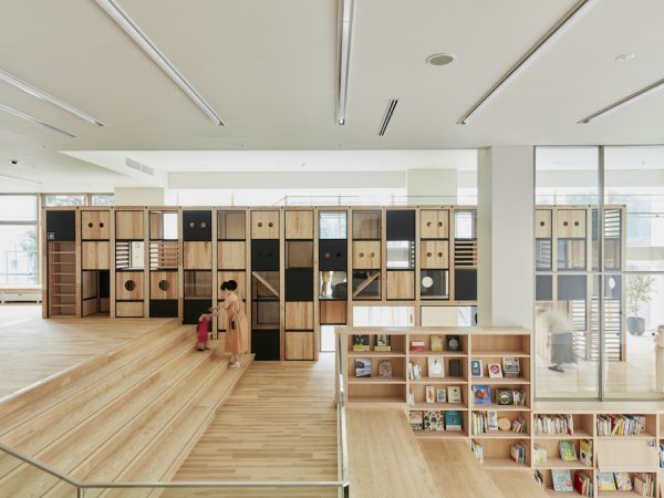 エントランスから上がった２階には、子どもたちが大喜びの大きな箱型のジャングルジム。室内は木材を多用した落ち着いた空間に。