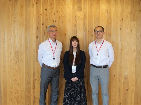 左より、ライフデザイン・カバヤ株式会社 開発本部広報課課長 丹原 浩司さん、同FC事業本部管理課  坂本 結理さん、同加盟開発部管理課次長 平田 拓也さん。背景の壁面は、実際のモデルハウスで使われているスギ材のCLTパネル