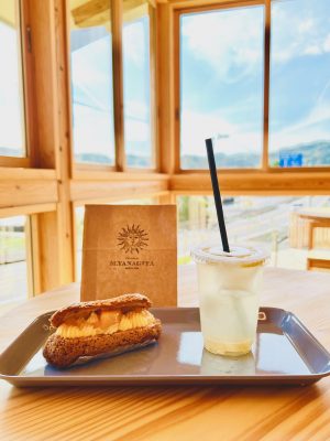 ▲『patisserie M.YANAGITA』のスペシャリテ「エクレール」は、サクサクのクッキー生地にレモンクリームがのった爽やかなスイーツで、果肉たっぷりのレモネードとも相性抜群。錦江湾を一望するガラス張りの店内でイートインできる（筆者撮影）