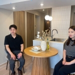 木製のスタイリッシュな丸テーブルを囲んで、右側に女性、左側に男性が座っている。